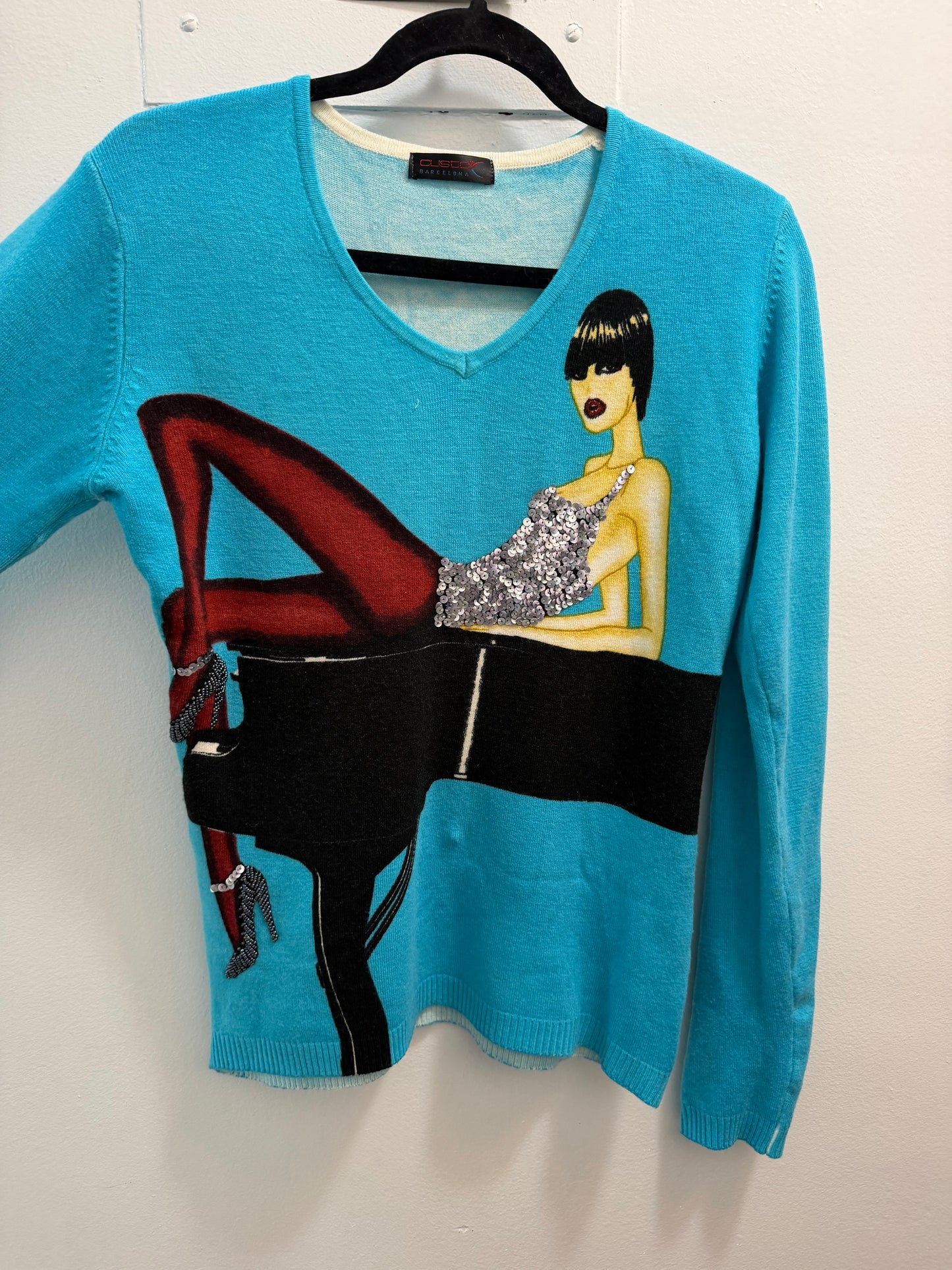 Custo Barcelona turquoise sweater with woman on piano bedazzled